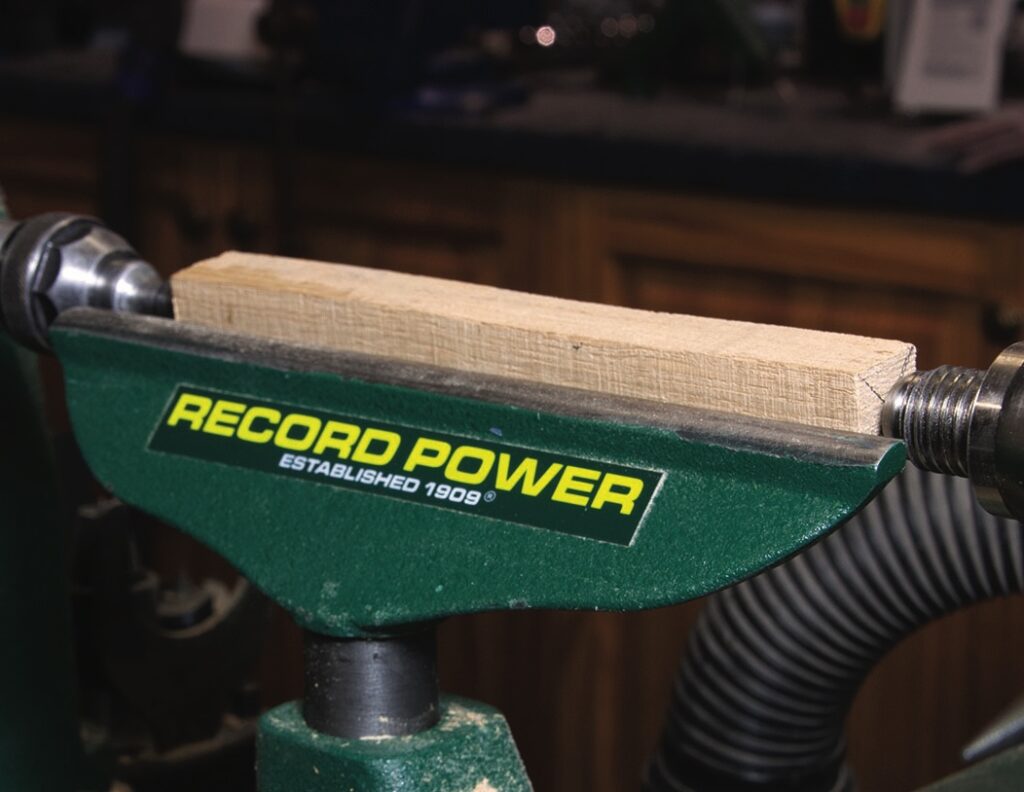 Wooden board secured in green woodworking vice
