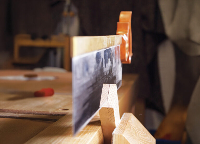 Saw cutting wood in workshop