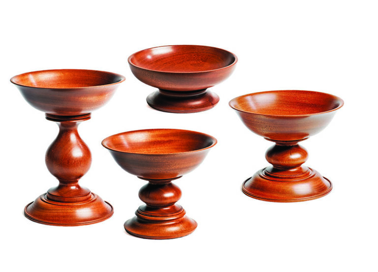 Set of four wooden pedestal bowls