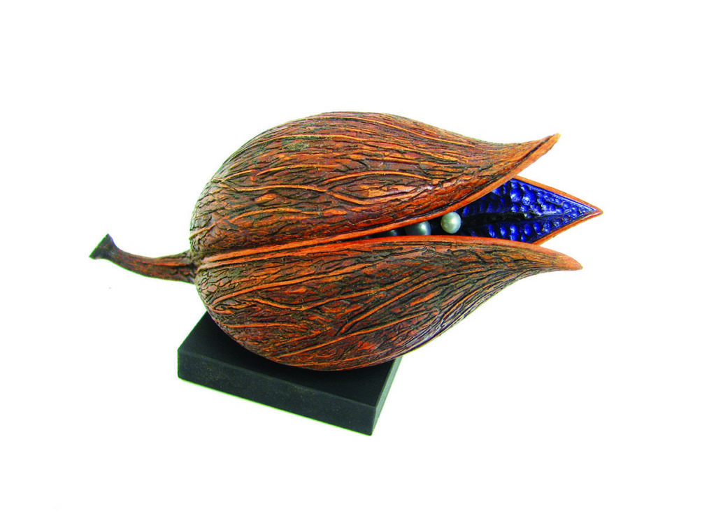 Wooden seed pod sculpture with blue interior