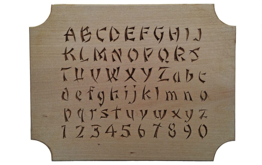 Wooden board with carved alphabet and numbers.