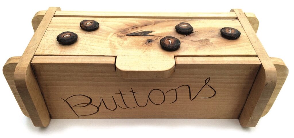 Wooden box with buttons engraved.