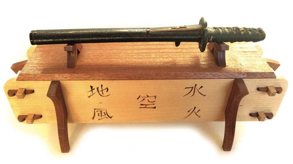 Decorative sword on engraved wooden stand.