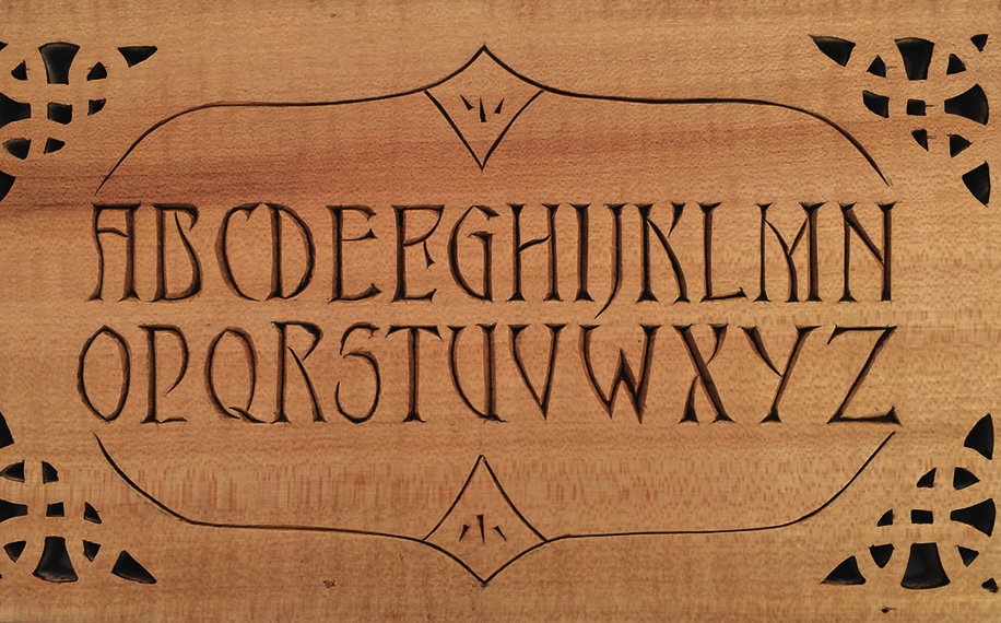 Carved wooden letters in decorative style alphabet.