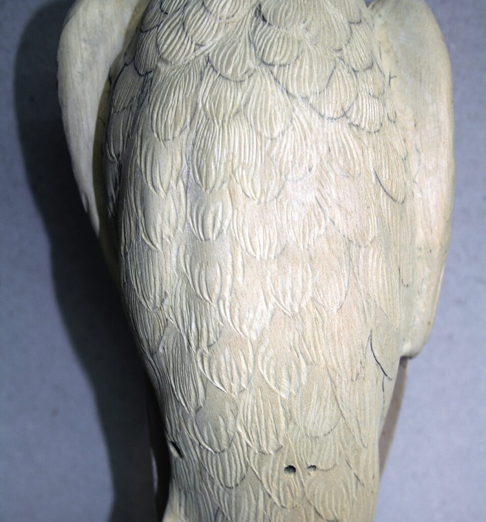 Close-up of textured feathers on a sculpture.