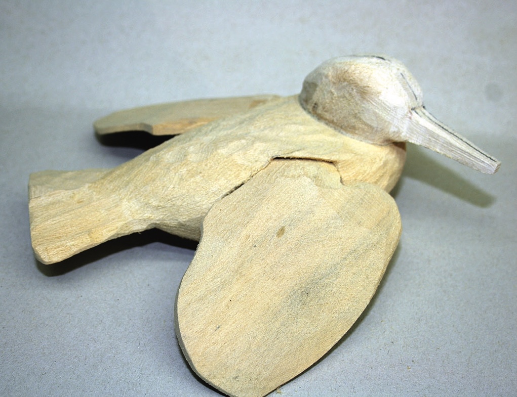 Carved wooden bird on display.
