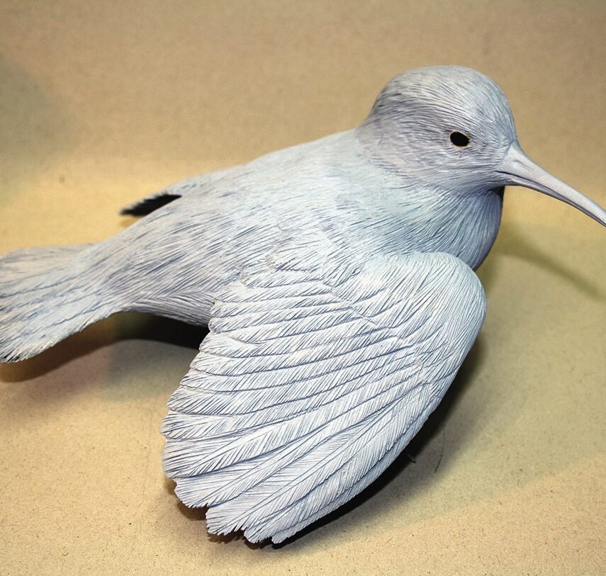 White bird sculpture with detailed feathering