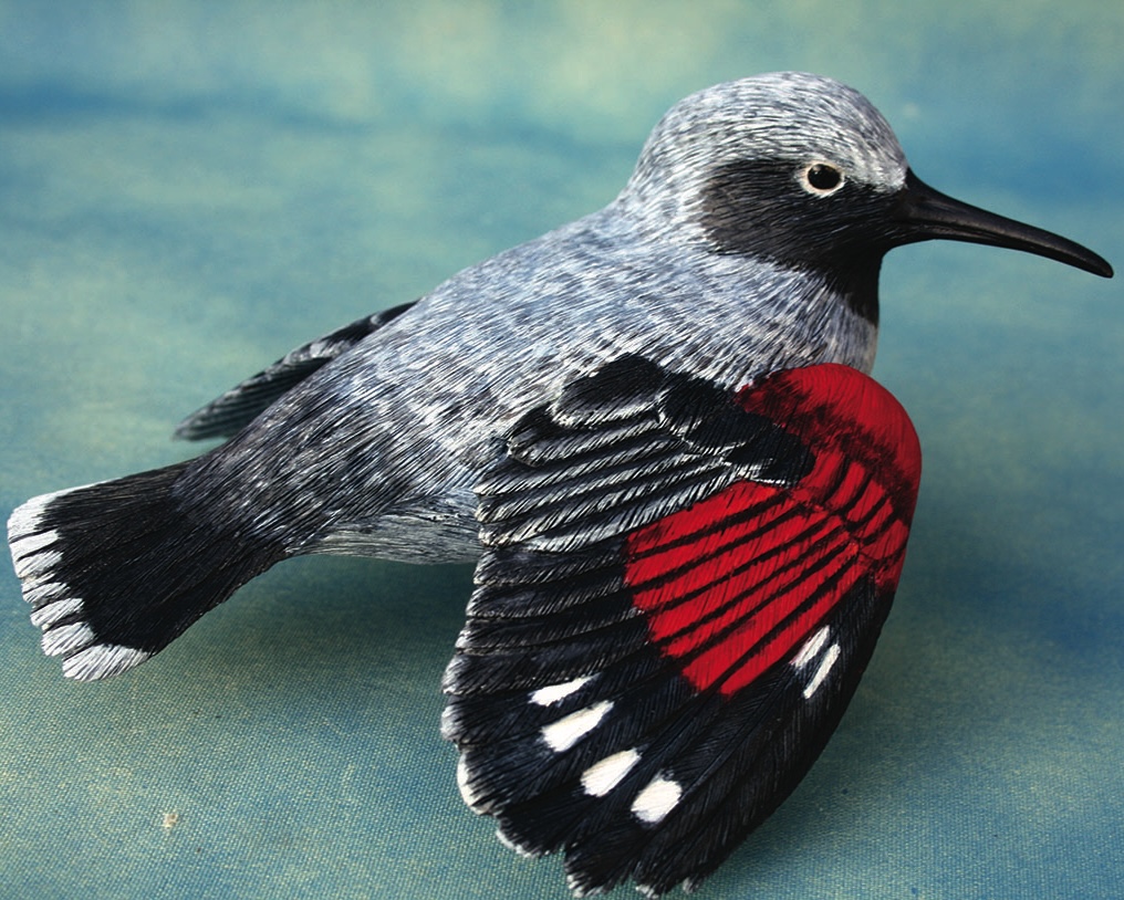 Detailed model of a bird with red markings.