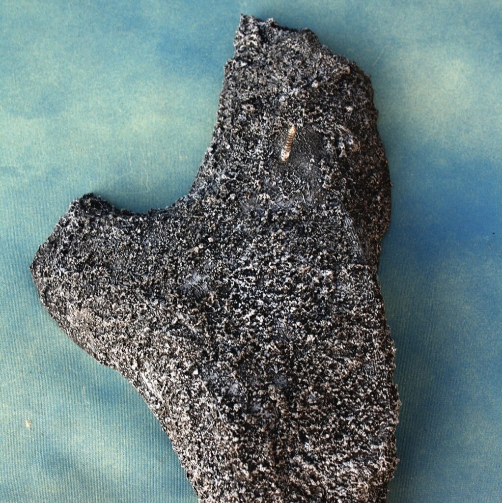 Close-up of a dark, porous meteorite rock