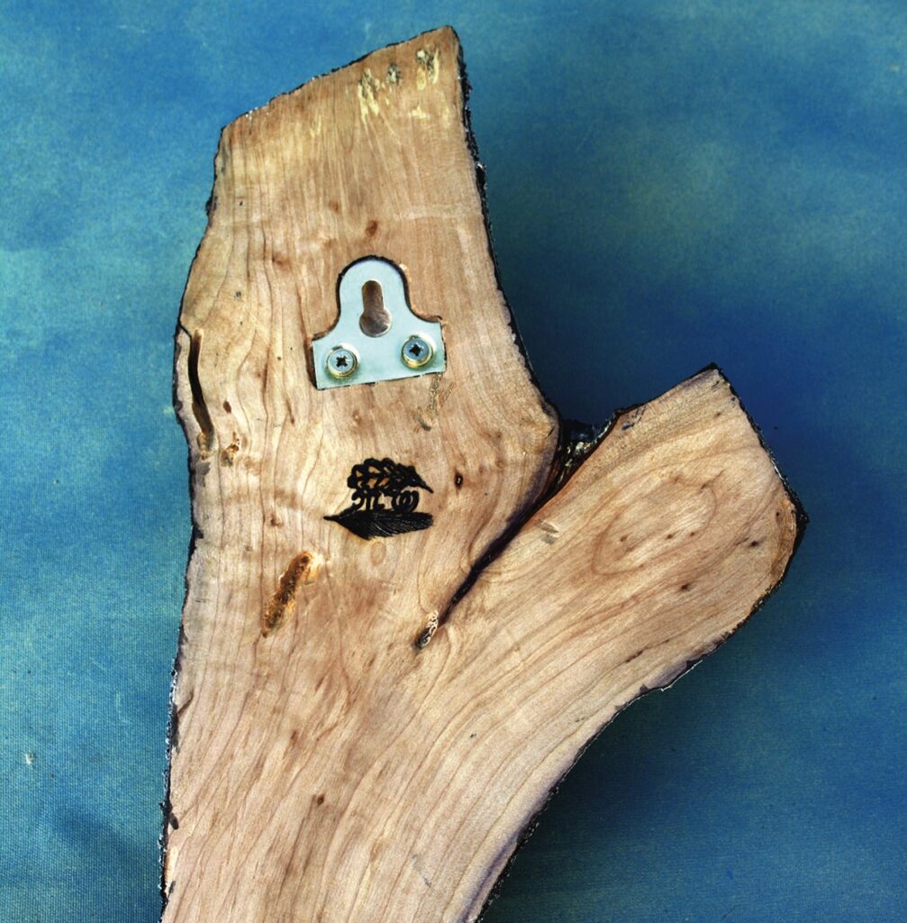 Wood plank with hook and tree design