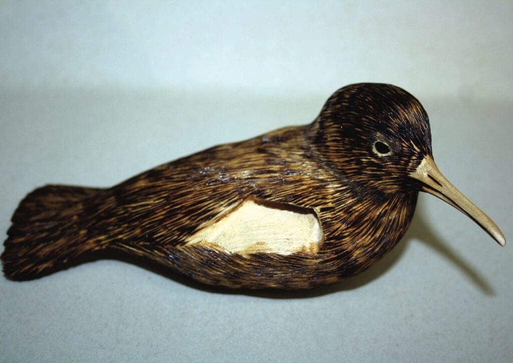 Hand-carved wooden bird sculpture on display.