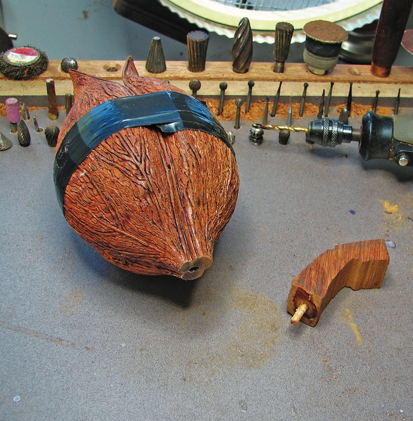 Wooden gourd with drill and carving tools.