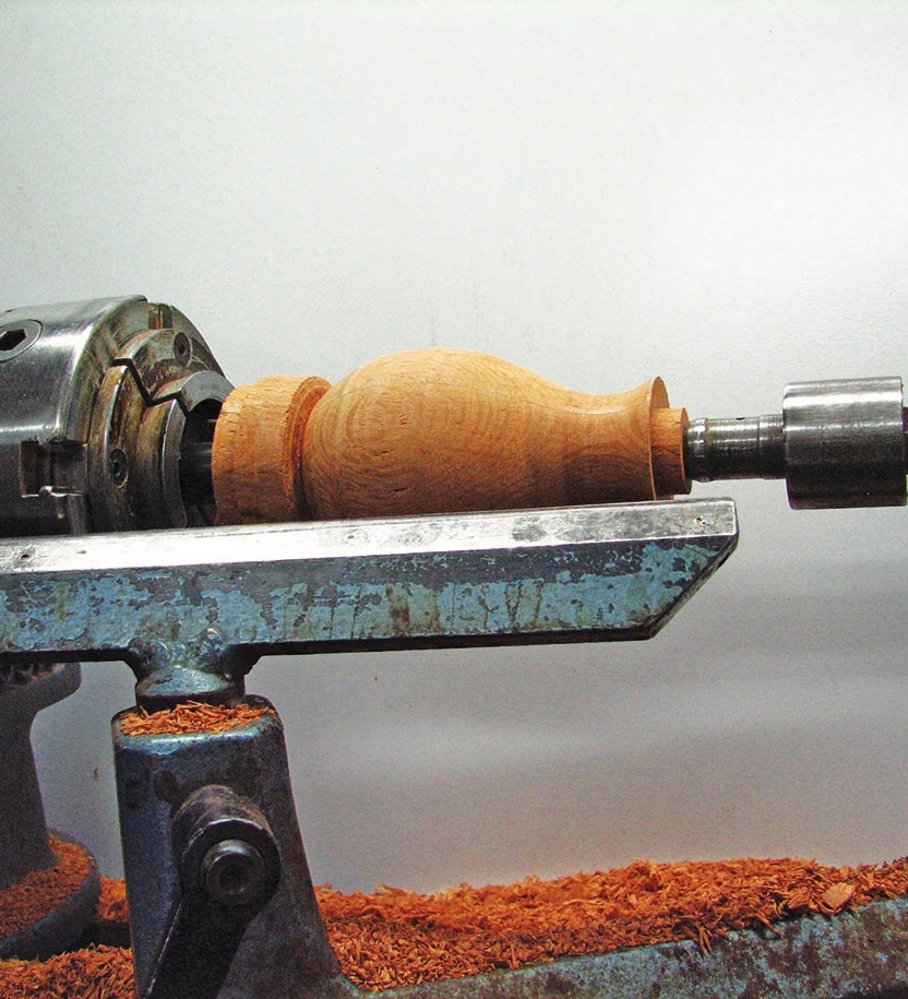 Woodturning a wooden spindle on a lathe machine.