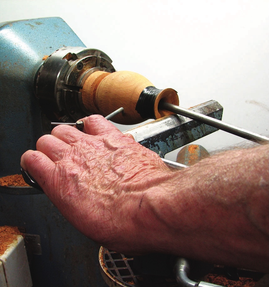 Person using a lathe for woodturning.
