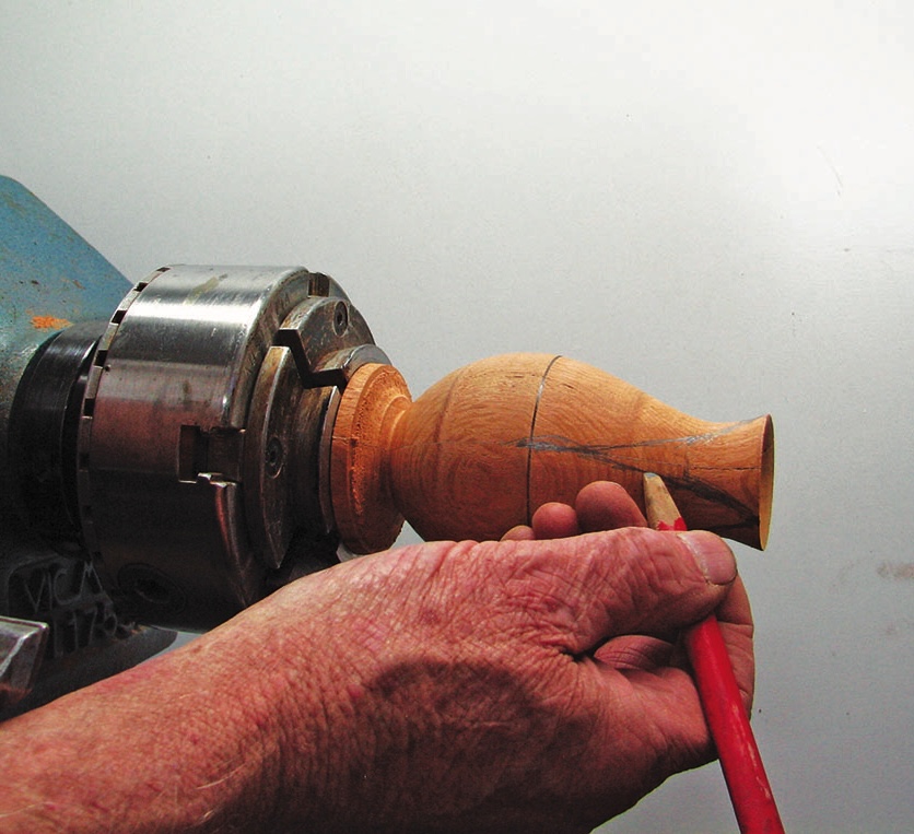 Woodturning with lathe and pencil marking wood