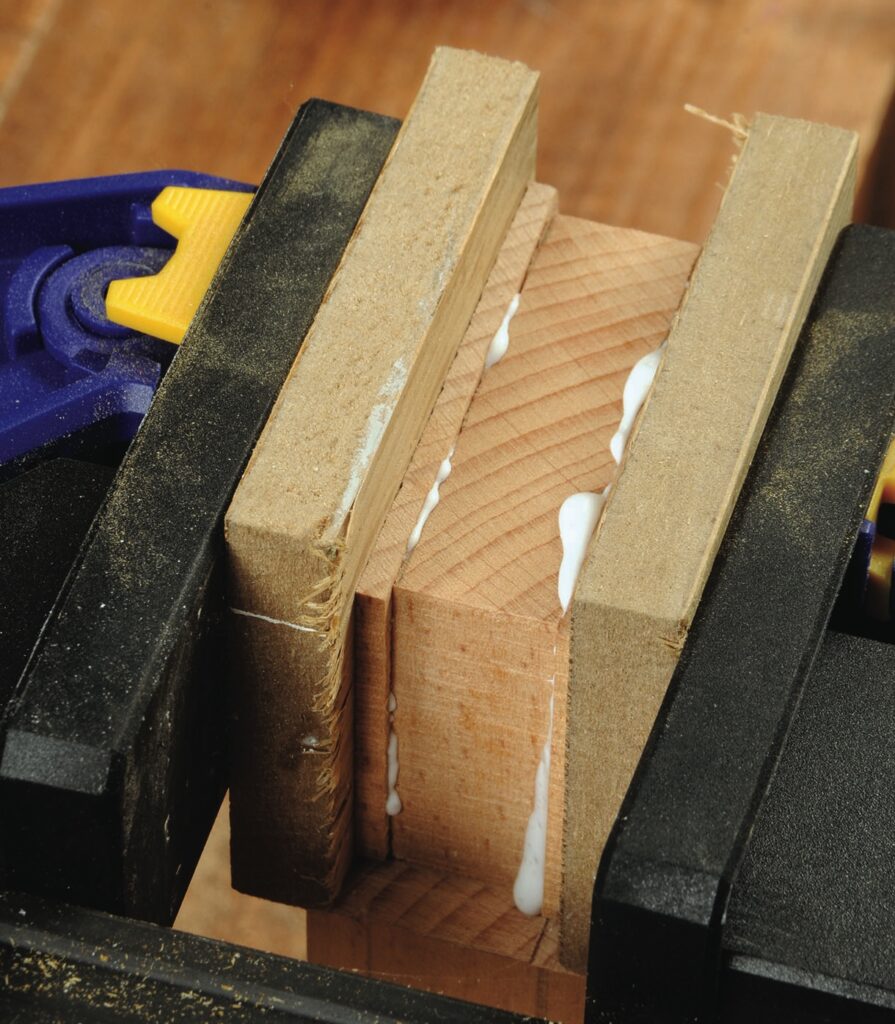 Glueing wood pieces with clamp.