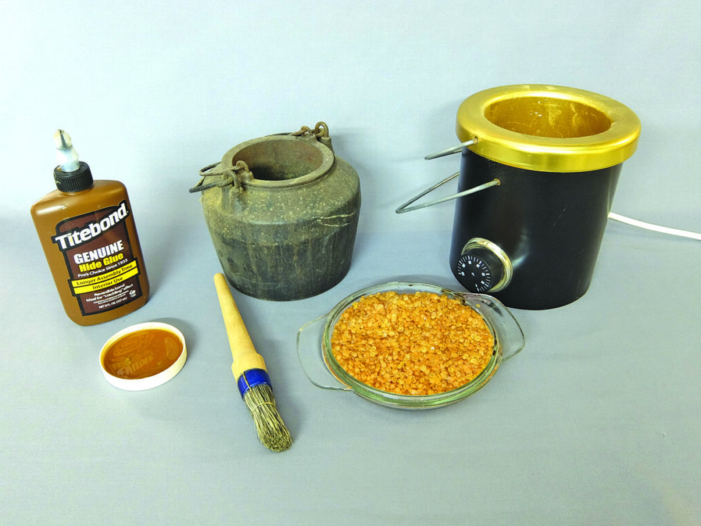 Hide glue materials and tools display on table.