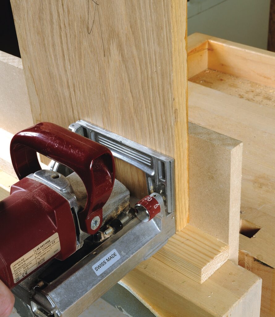 Biscuit joiner cutting wooden board joint neatly