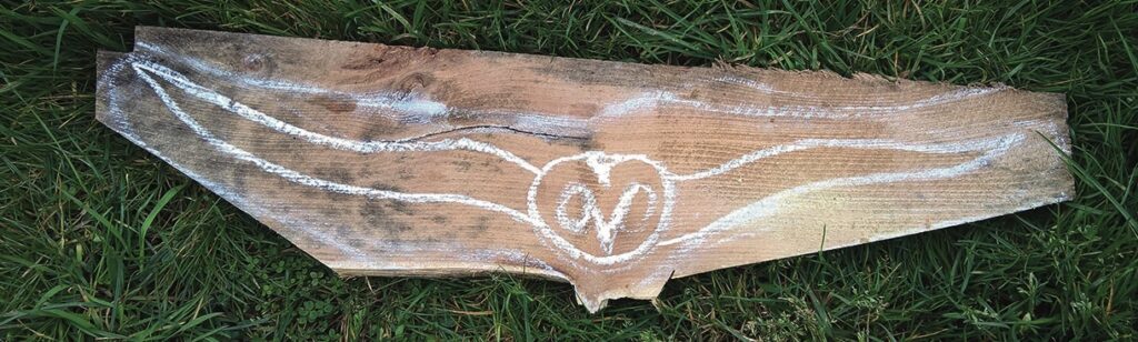 Wooden plank with painted white wings design