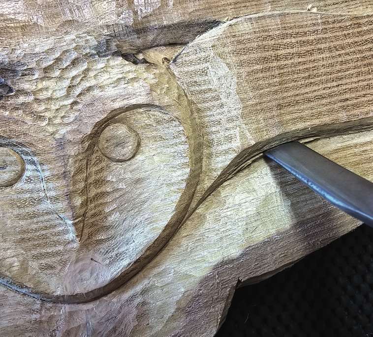 Carving chisel detailing an owl in wood