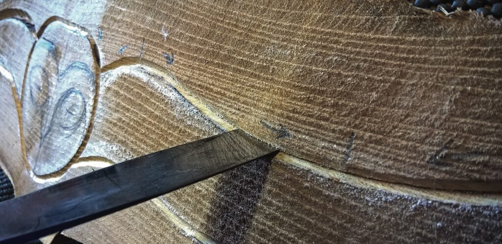 Close-up of wood carving with chisel