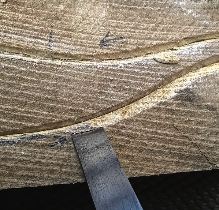 Wood carving with chisel in action