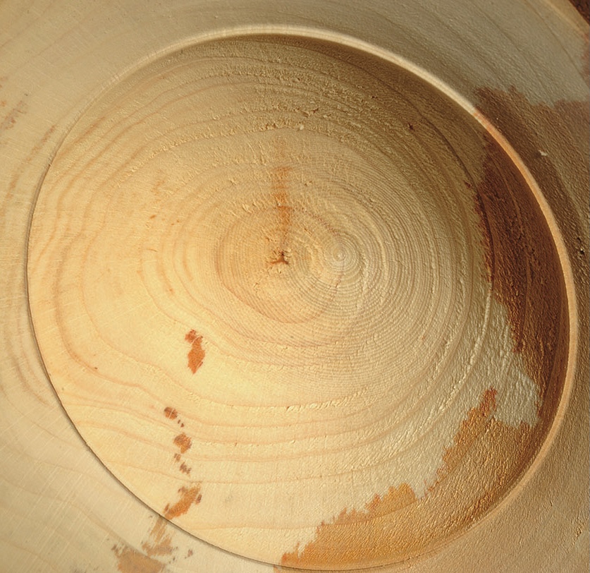 Close-up of wooden plate texture with grain pattern.