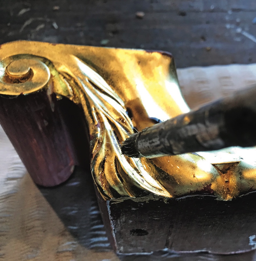 Gilding wooden frame with a brush