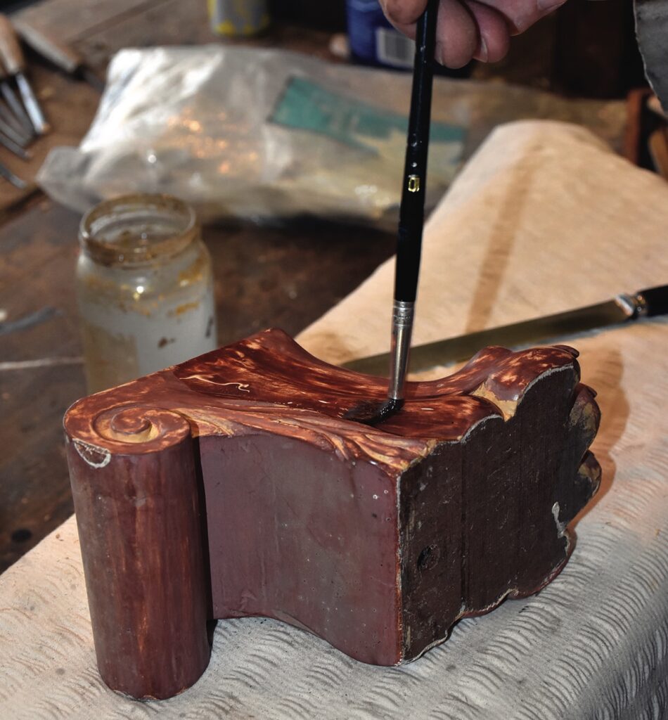 Restoration of wooden furniture with paintbrush