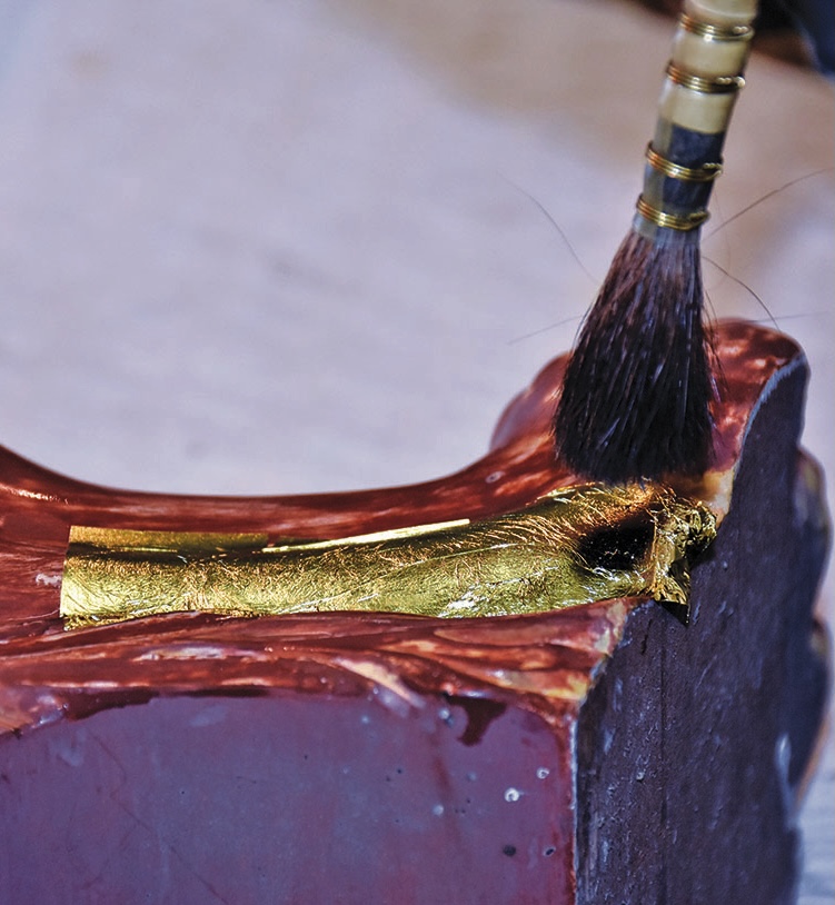 Gold leaf applied on ceramic art piece.