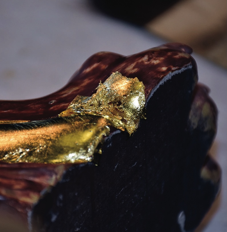 Close-up of gold leaf on dark surface