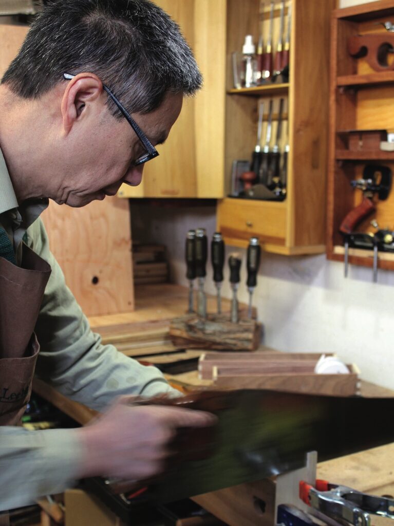 Carpenter cutting wood in a workshop