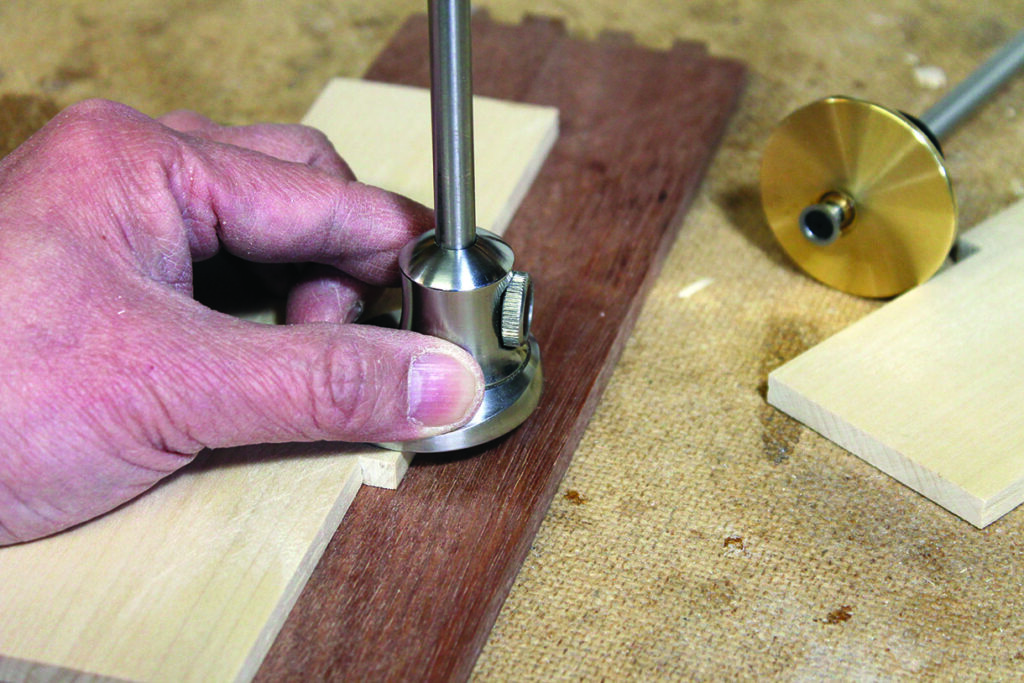Using marking gauge on wooden board