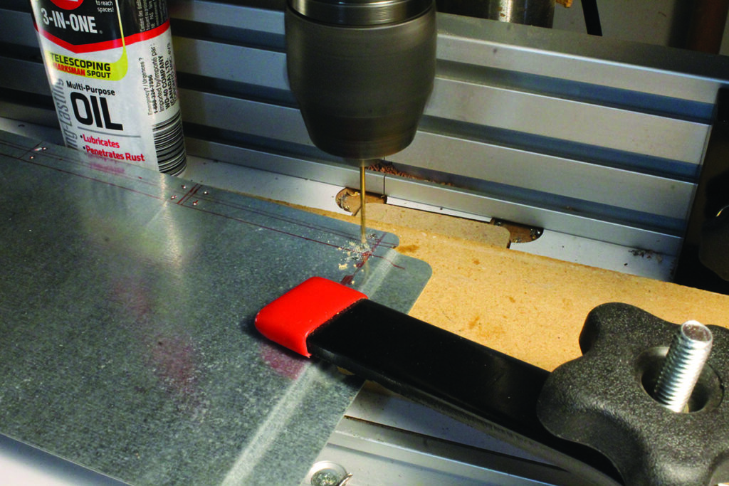 Drilling metal plate with drill press clamp