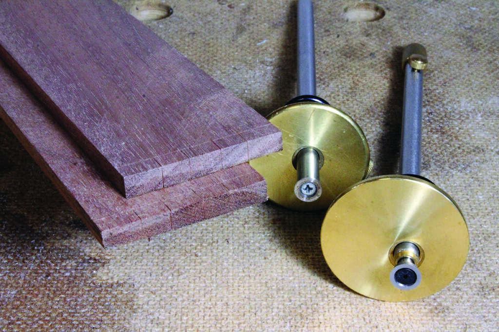 Woodworking tools and wooden planks on a workbench.