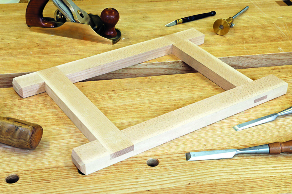 Woodworking tools on a workbench, including chisels.