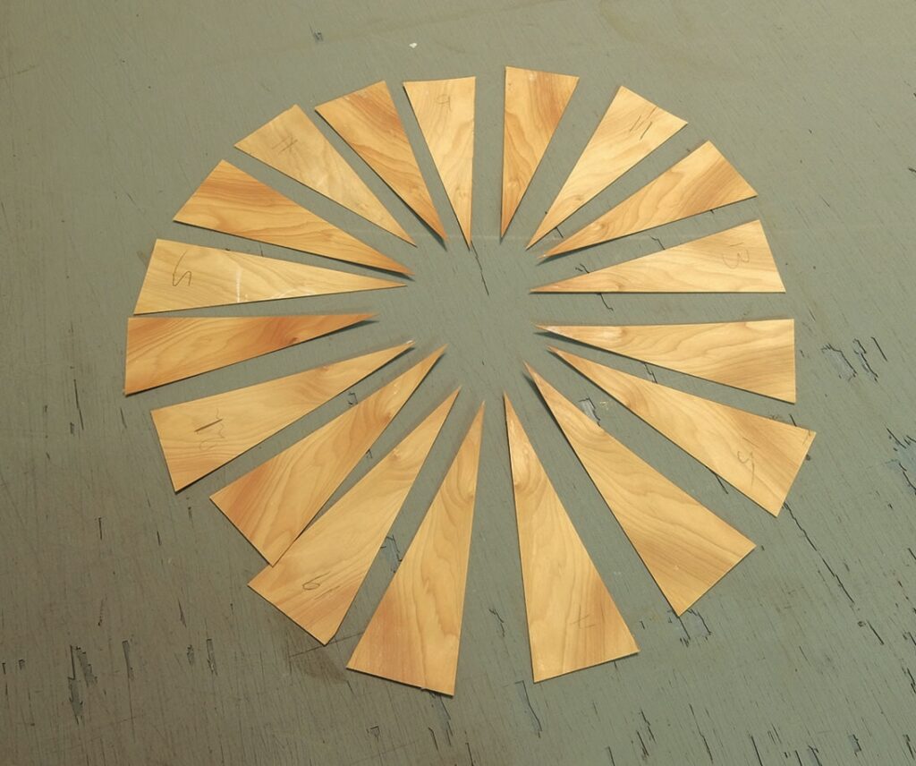 Wooden triangular pieces arranged in a circular pattern.