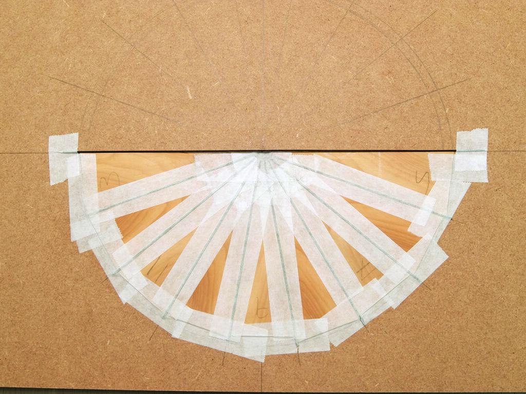 Wood and tape project on a brown board.