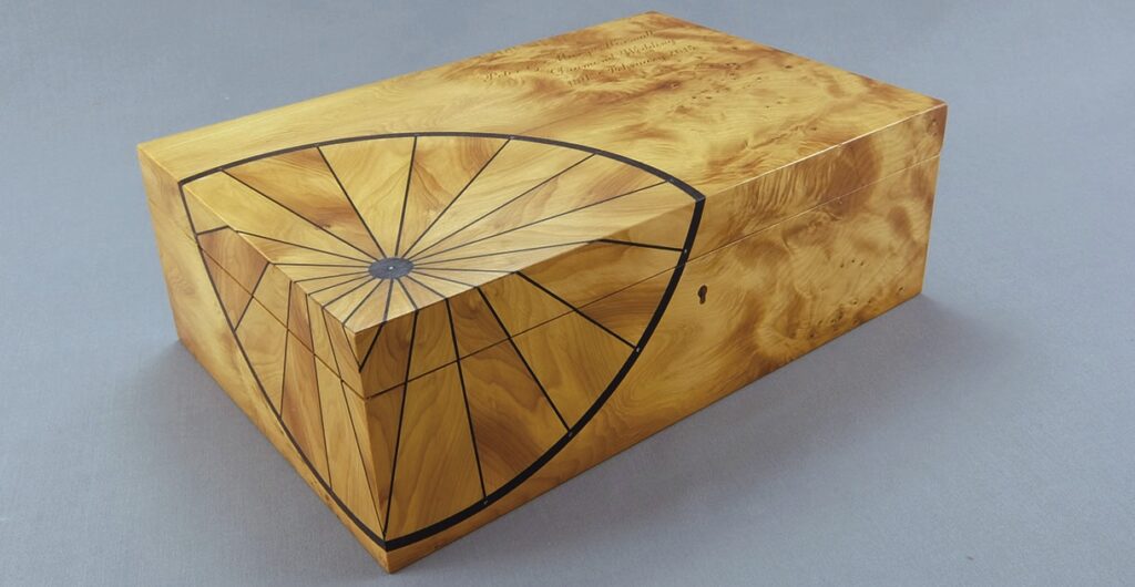 Wooden box with geometric inlay design.