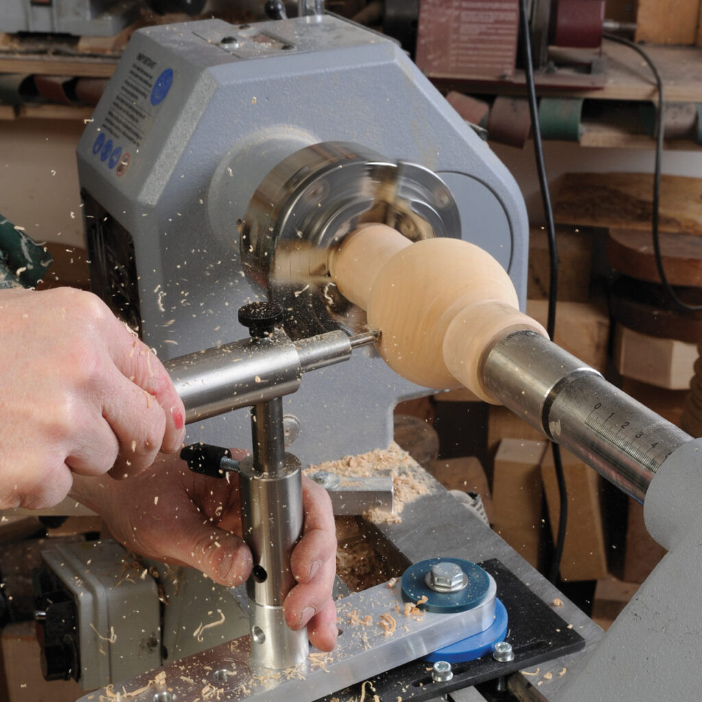 Person using wood lathe for carving