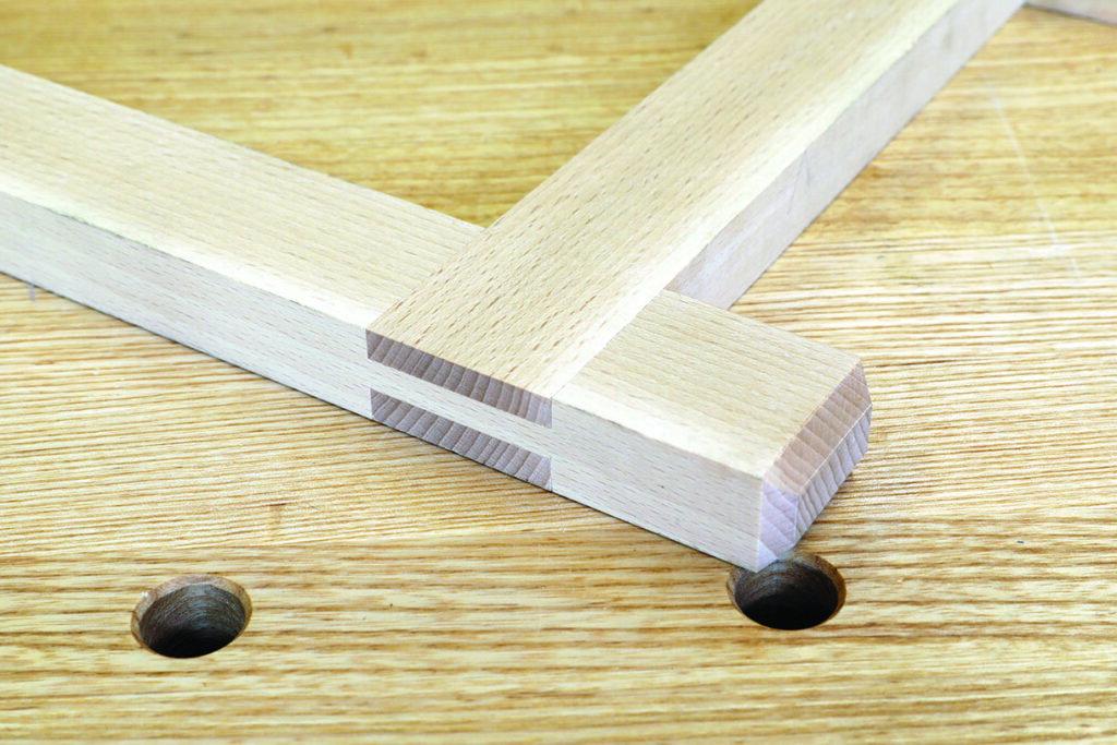 Wooden dowel joint on a workbench.