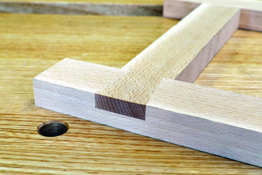 Wooden dowel joint on table surface.