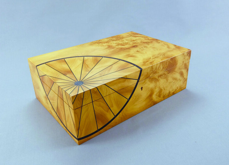 Wooden inlay box with geometric design.