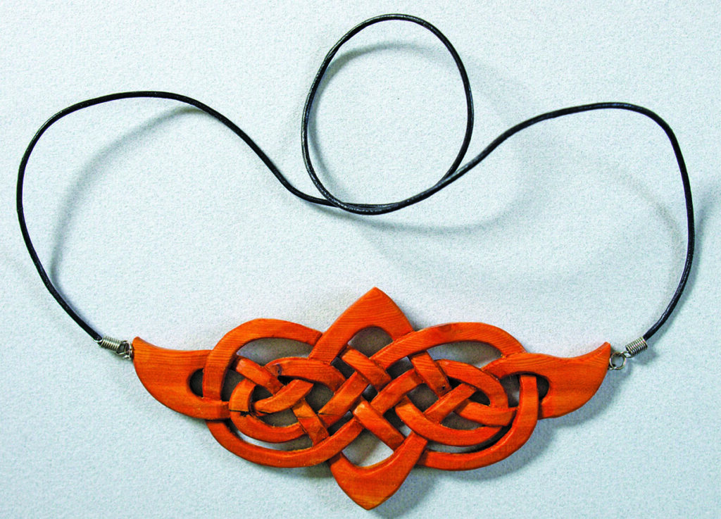 Wooden Celtic knot pendant with black cord.