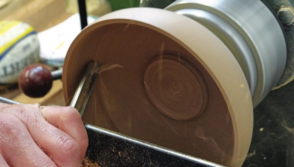 Woodturning a bowl with lathe chisel