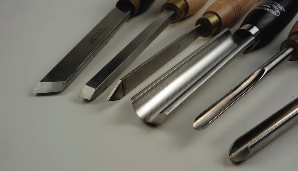 Set of woodturning chisels on white background.