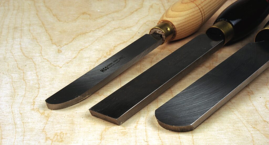 Woodturning gouges on wooden surface