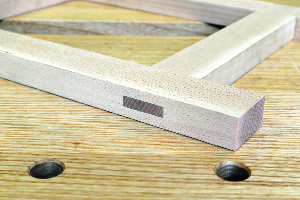Wooden frame joint on workshop table.