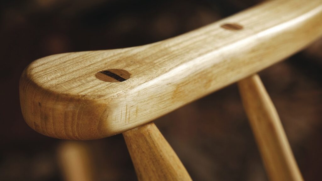 Close-up of wooden chair backrest with dowel joints.