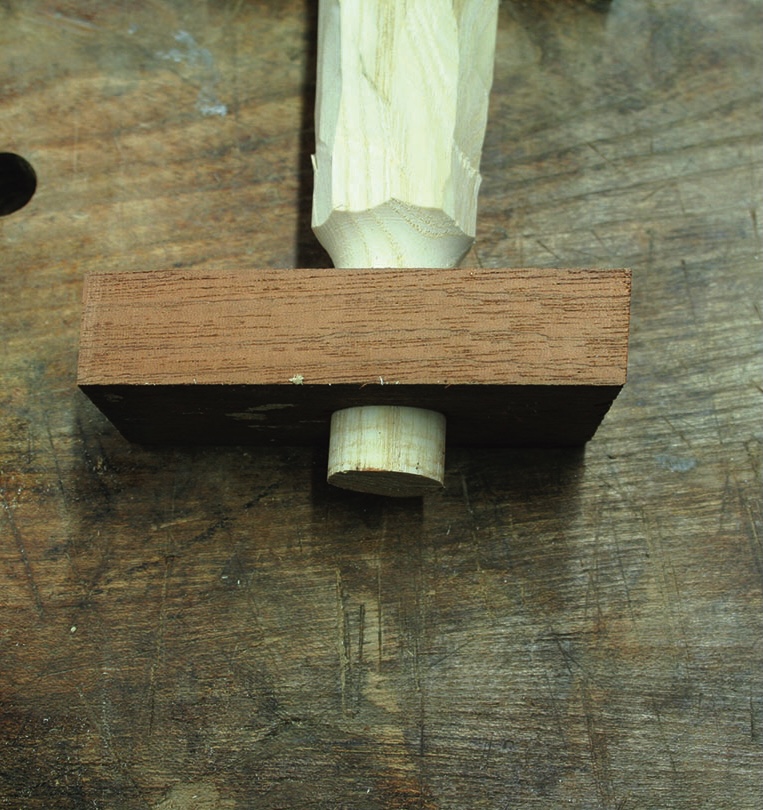 Wooden mortise and tenon joint on workbench.